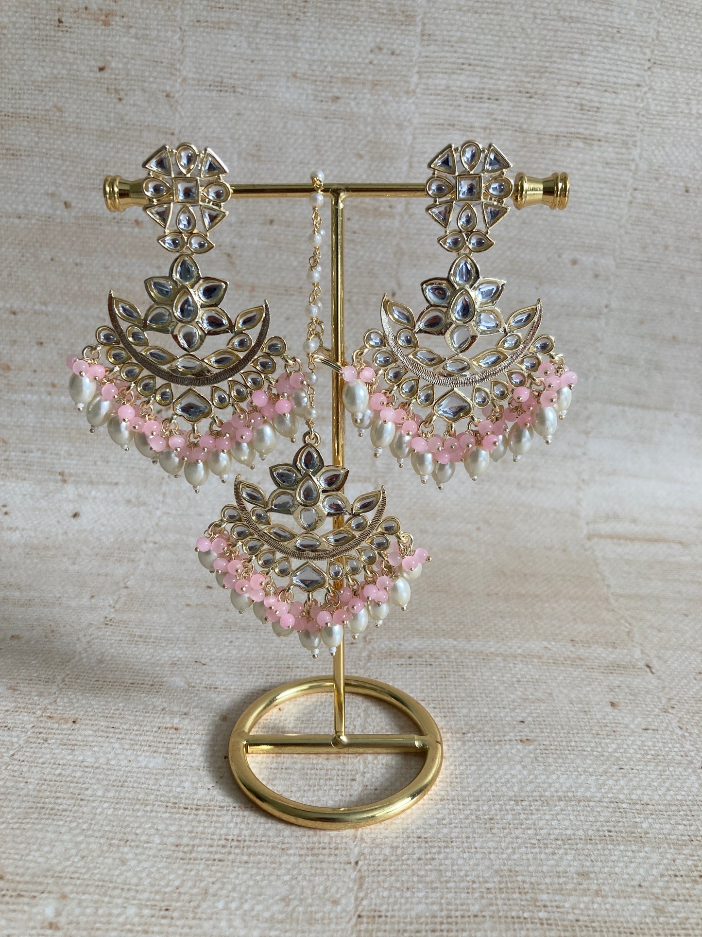 Ravina Pink Gold Plated Kundan Pearl Earrings And Tikka Set (ST942)