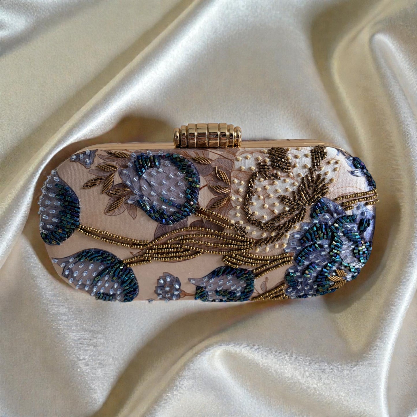 Decorative clutch bag with floral patterns on a satin surface