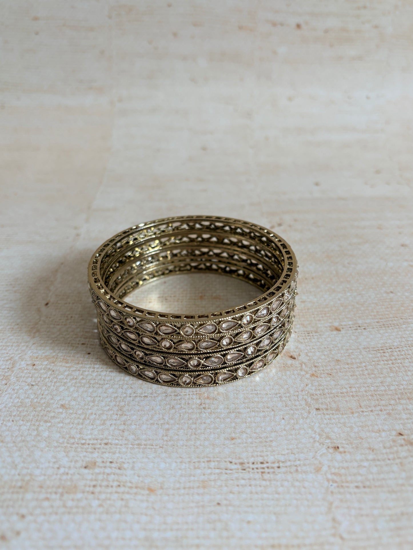 Decorative silver ring on a textured beige background