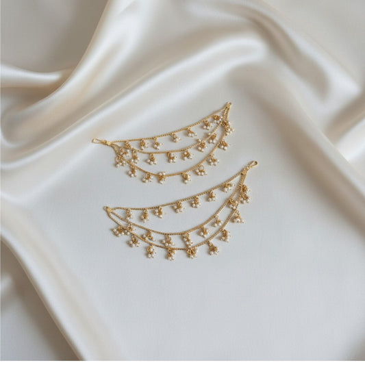 Gold necklace on a satin fabric background