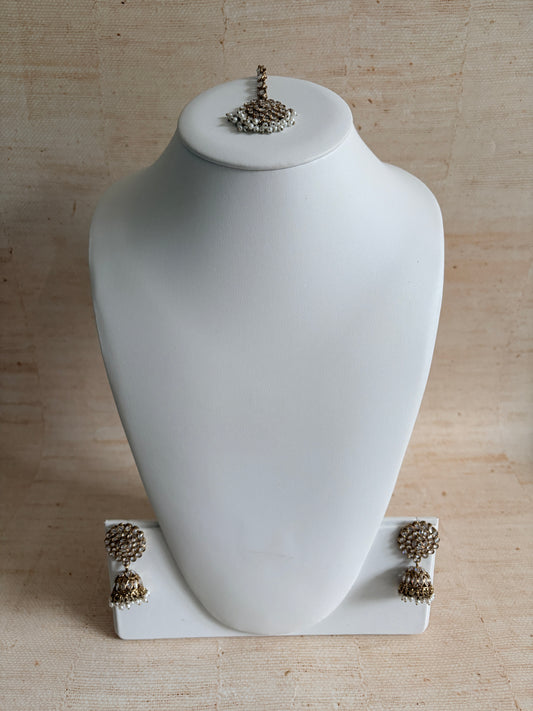 White vase with decorative elements on a beige background