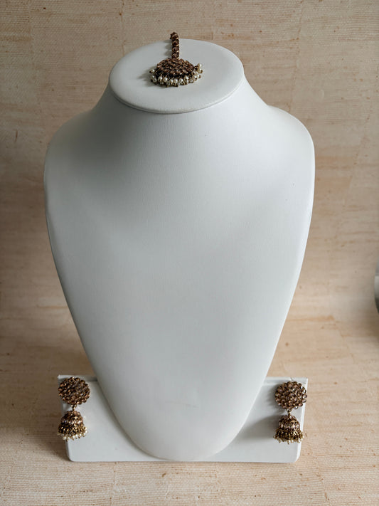 White wall-mounted lamp with decorative elements on a beige wall