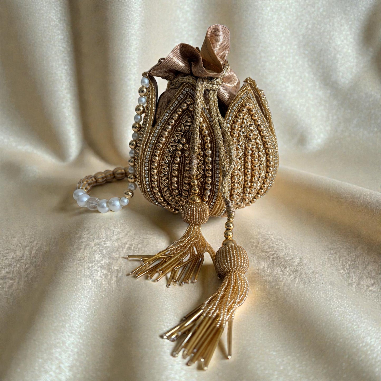 Decorative bag with tassels on a beige fabric background