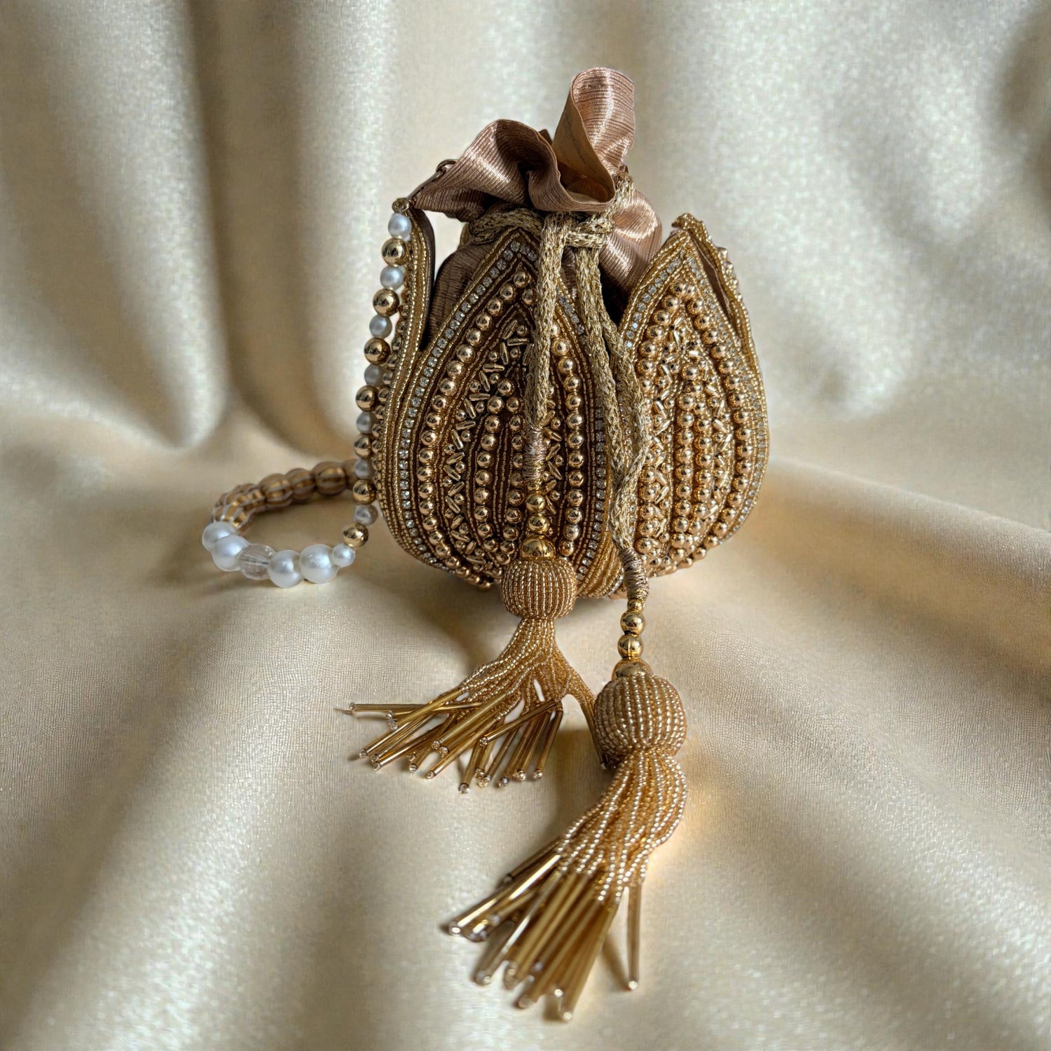 Decorative bag with tassels on a beige fabric background