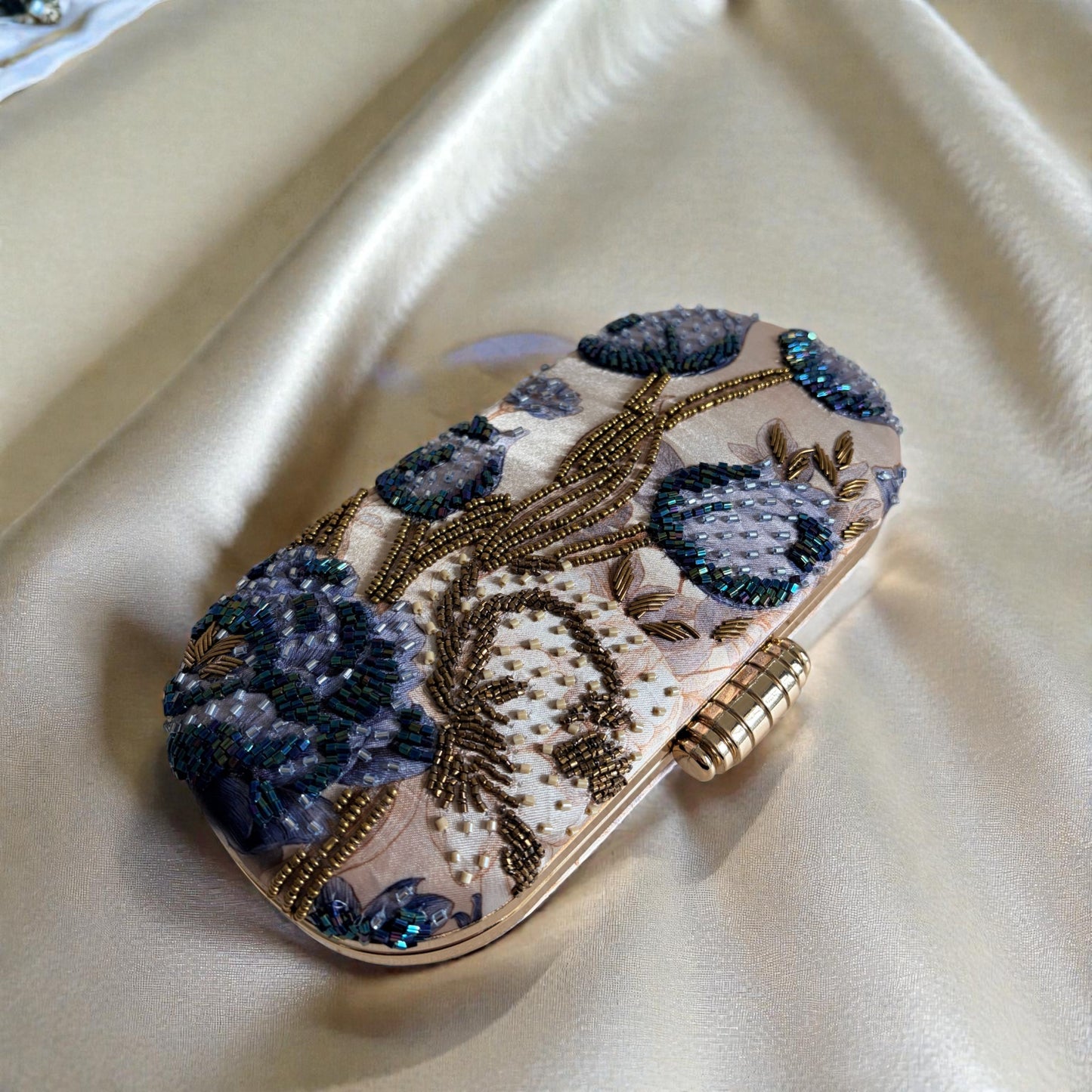 Decorative clutch with floral patterns on a beige fabric background