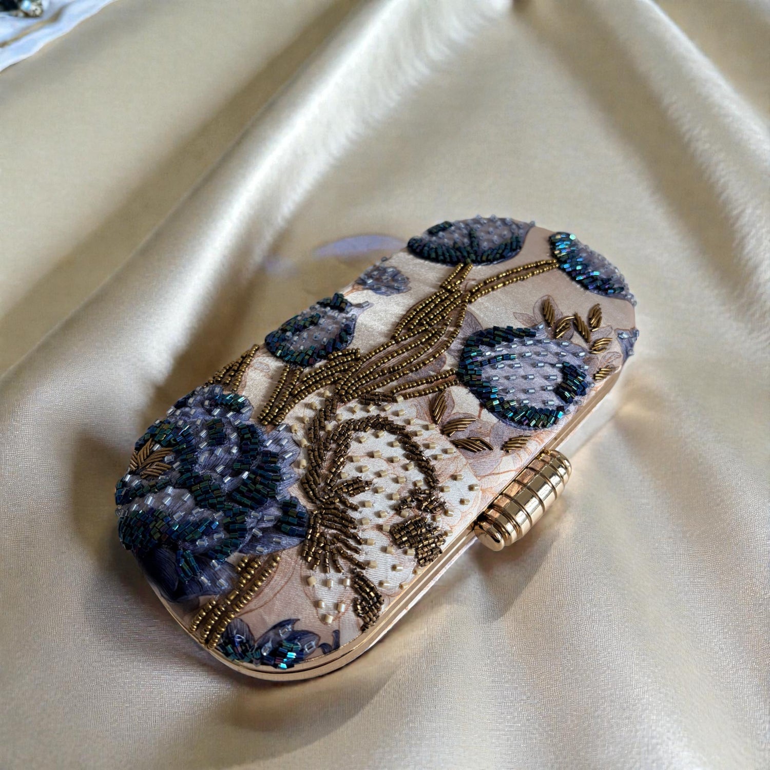 Decorative clutch with floral patterns on a beige fabric background