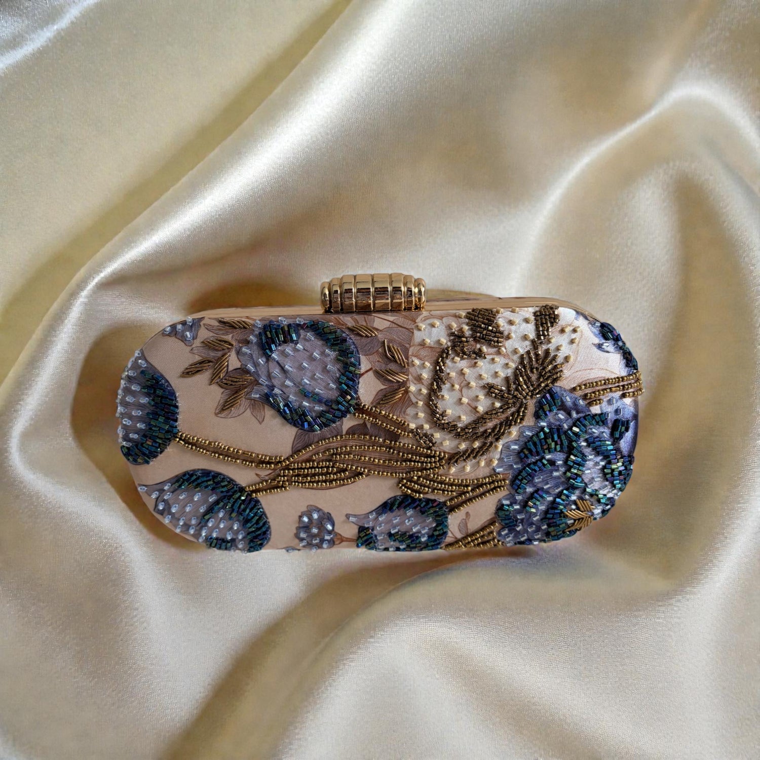 Decorative clutch bag with floral patterns on a satin surface