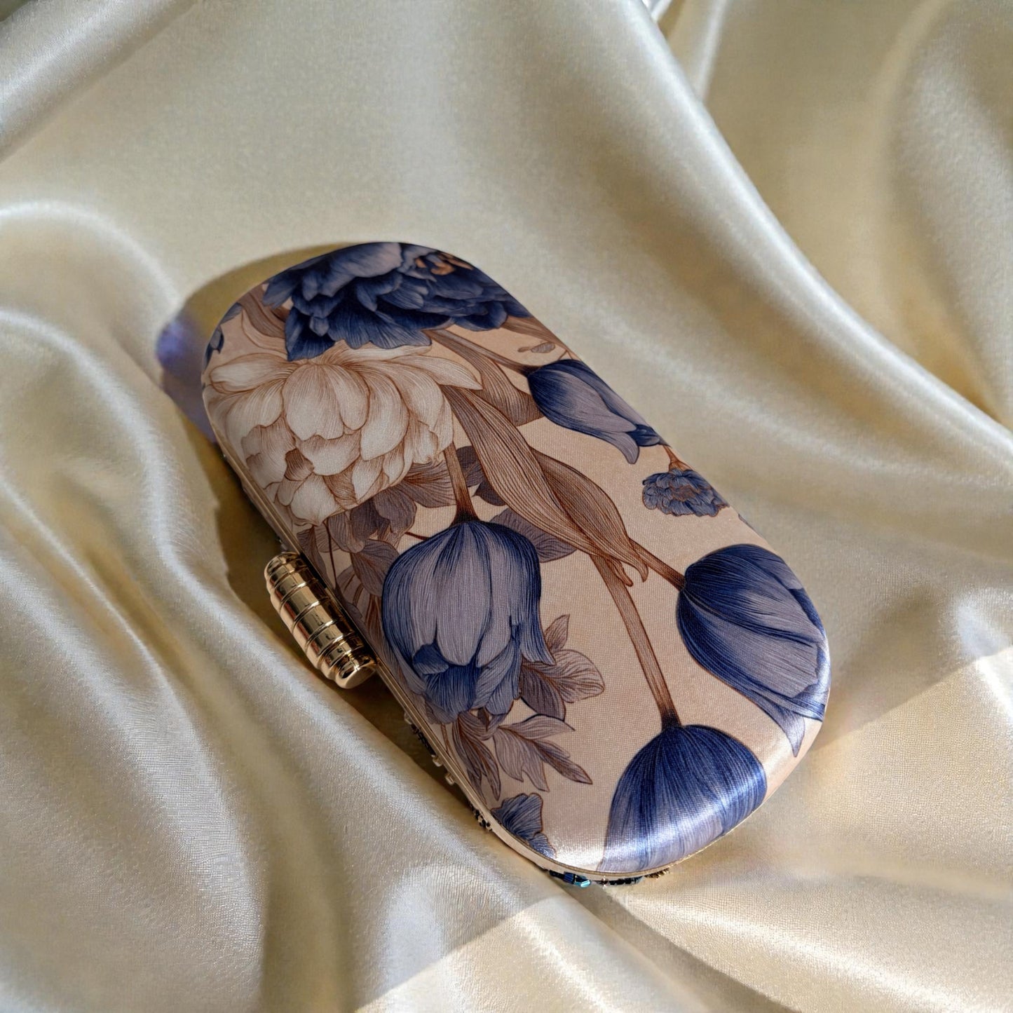 Floral-patterned clutch on a beige fabric background