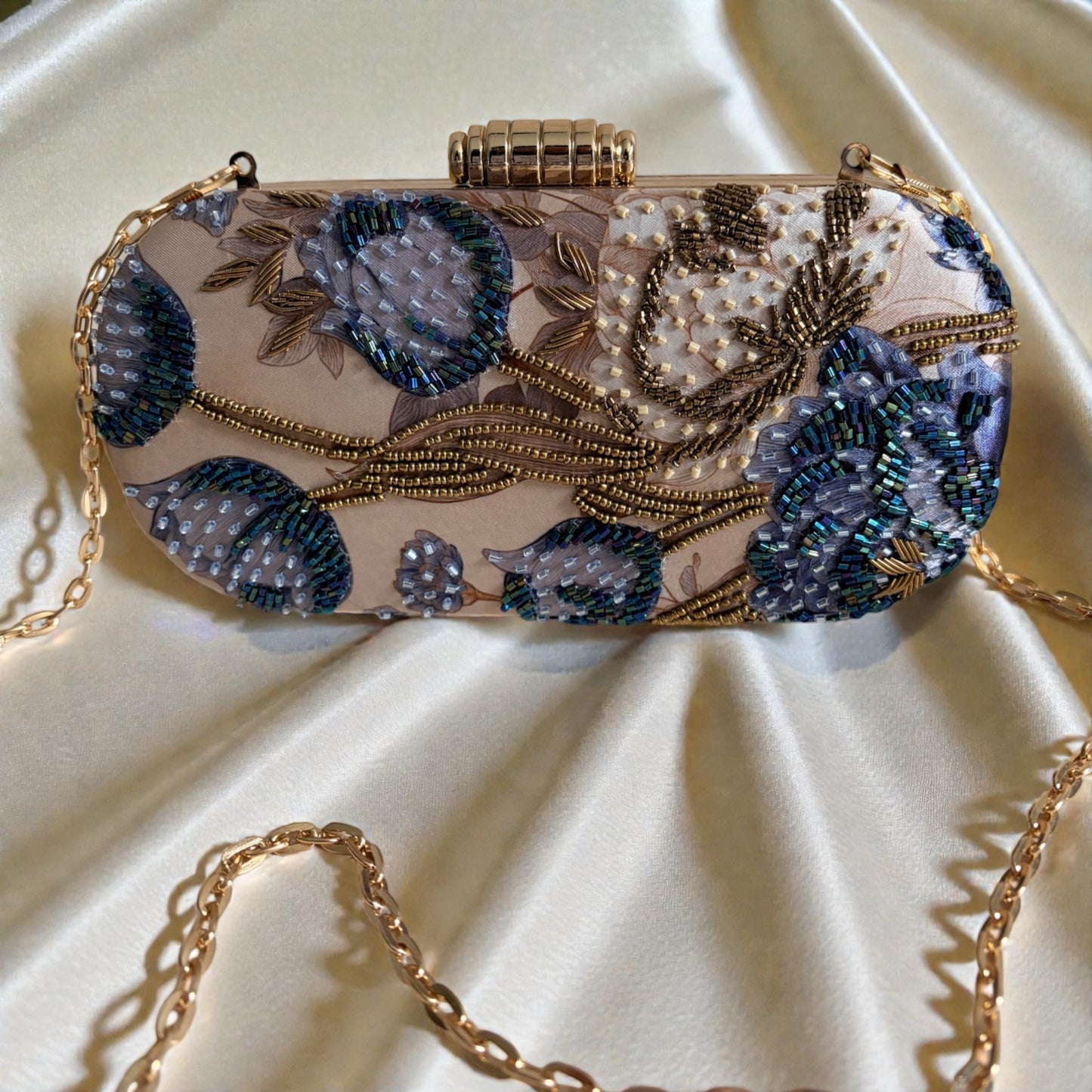 Decorative handbag with floral patterns and beading on a beige fabric background