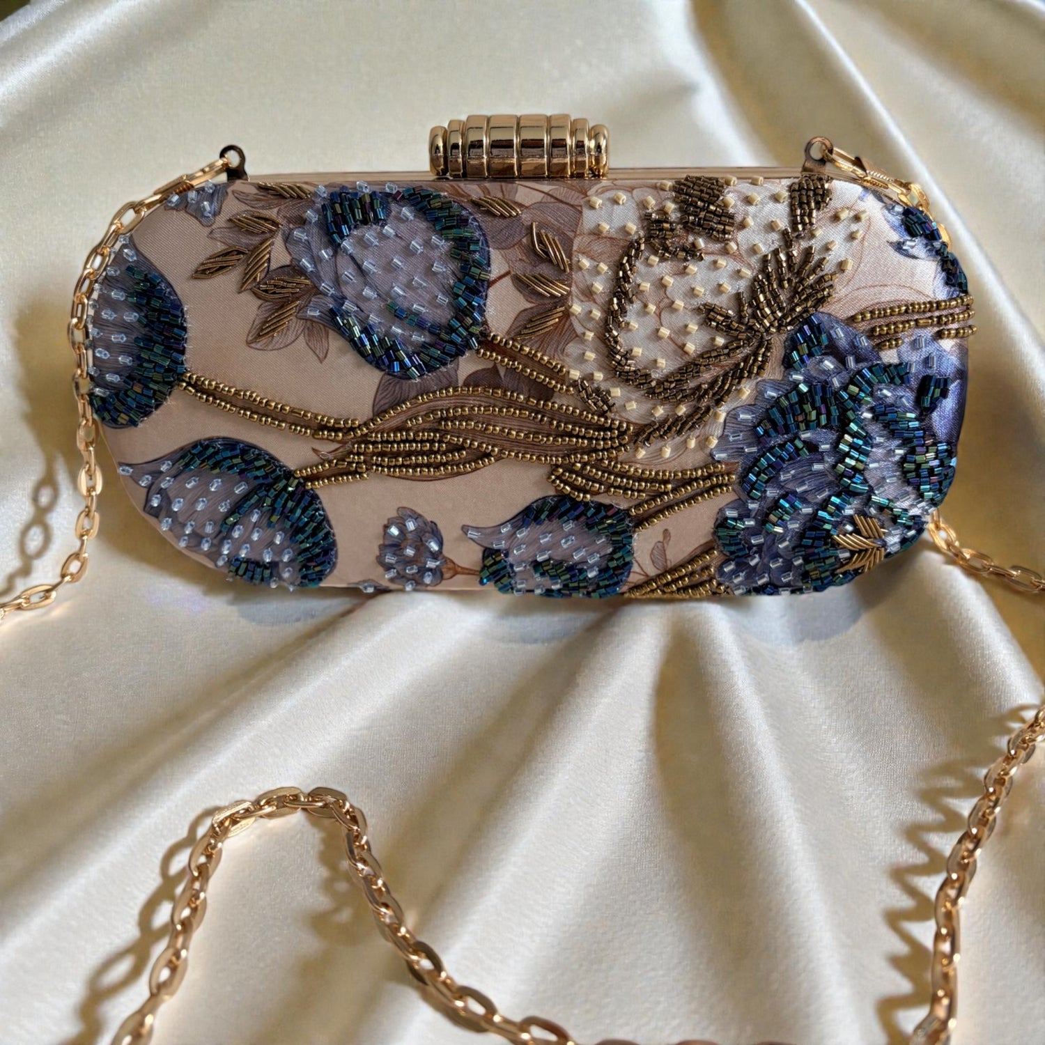 Decorative handbag with floral patterns and beading on a beige fabric background