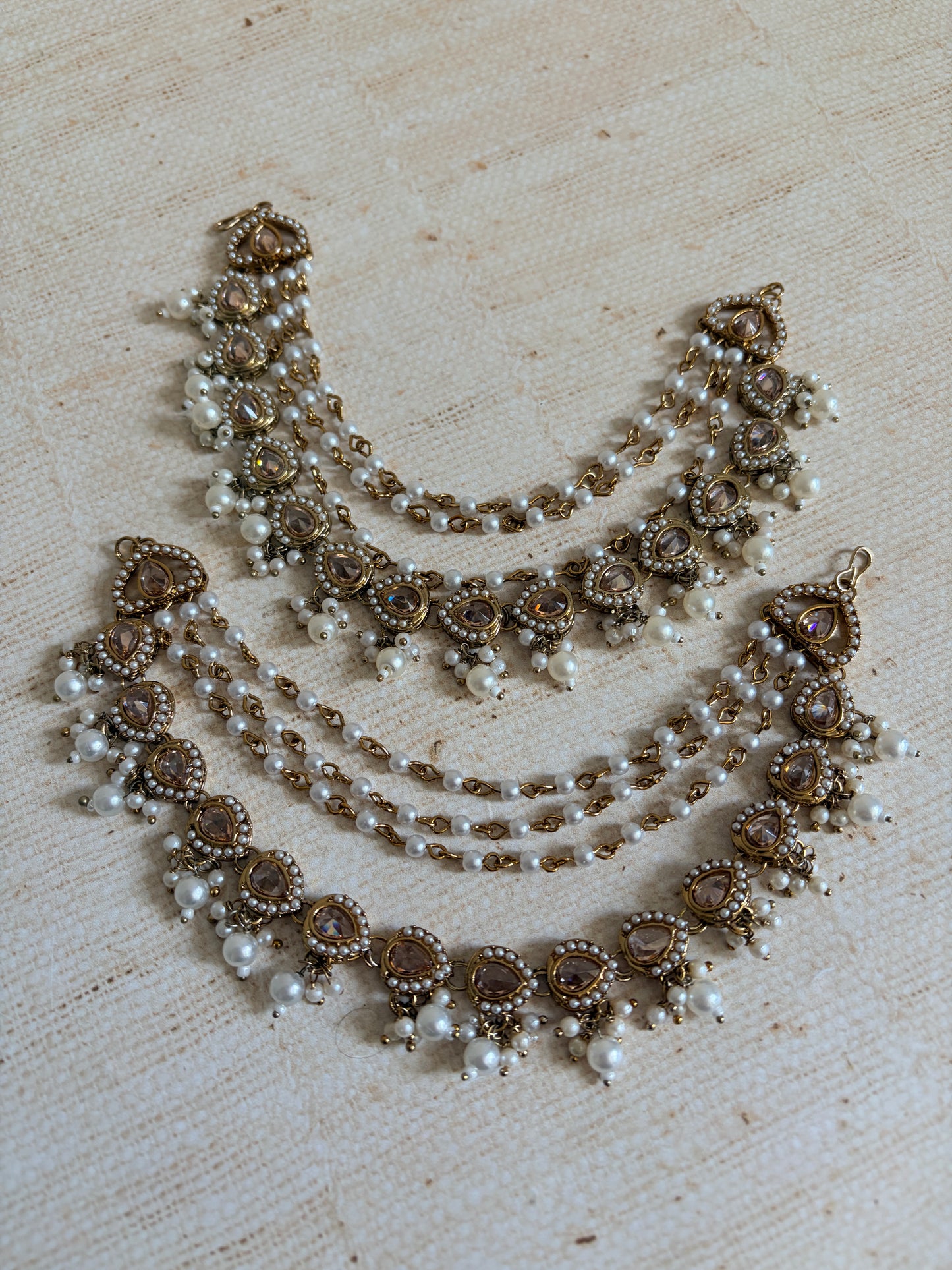 Jewelry set with pearls and crystals on a textured surface
