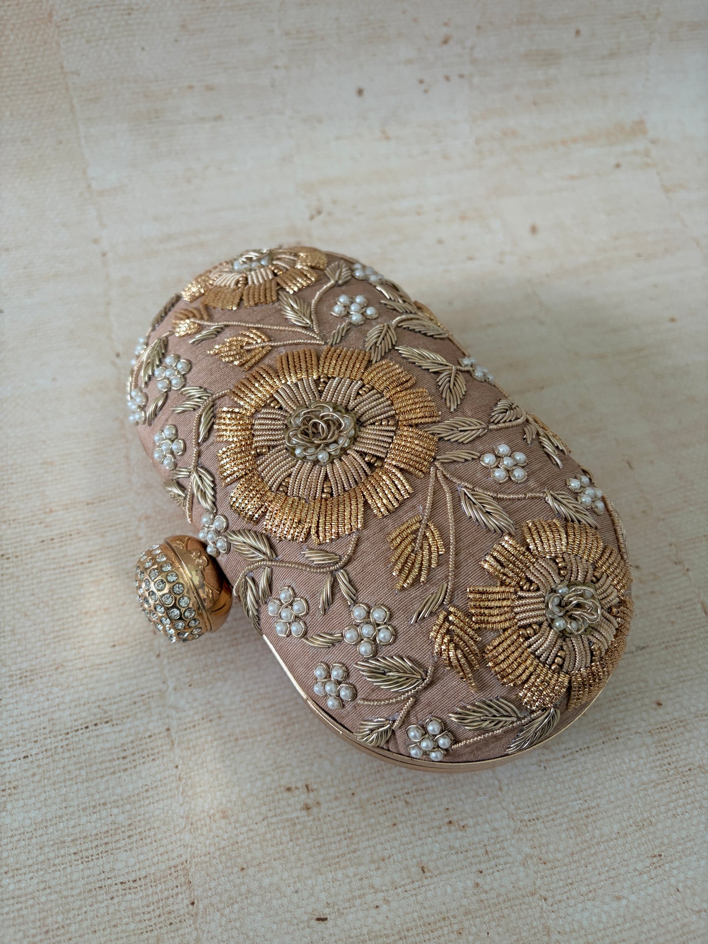 Decorative box with floral patterns on a textured beige background