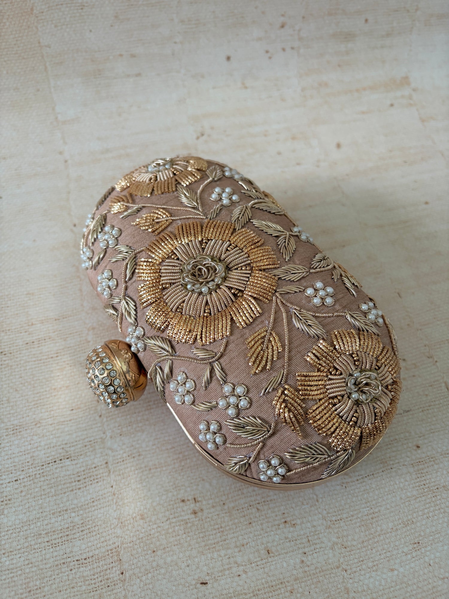 Decorative box with floral patterns on a textured beige background