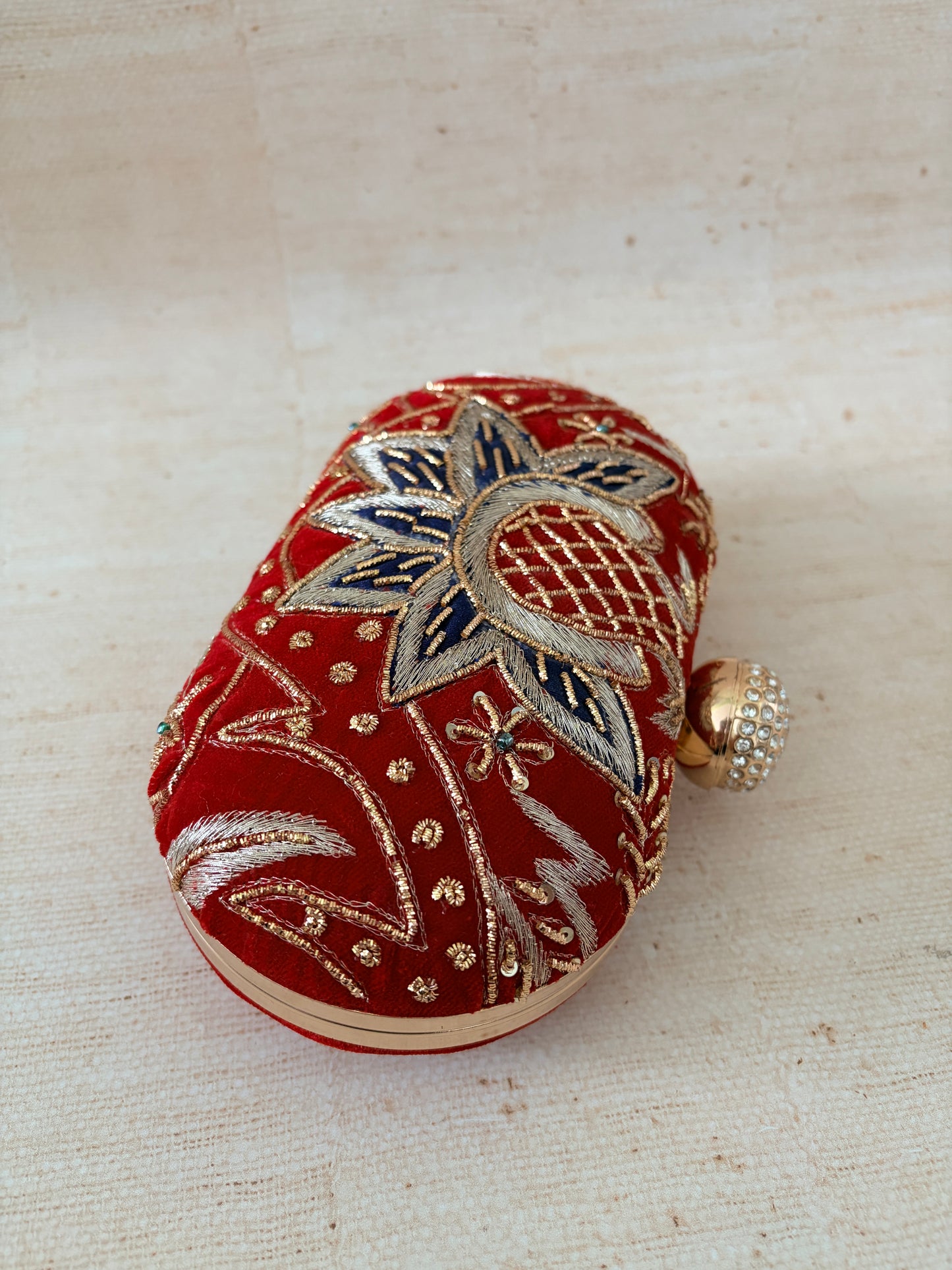 Decorative heart-shaped object with floral patterns on a beige background