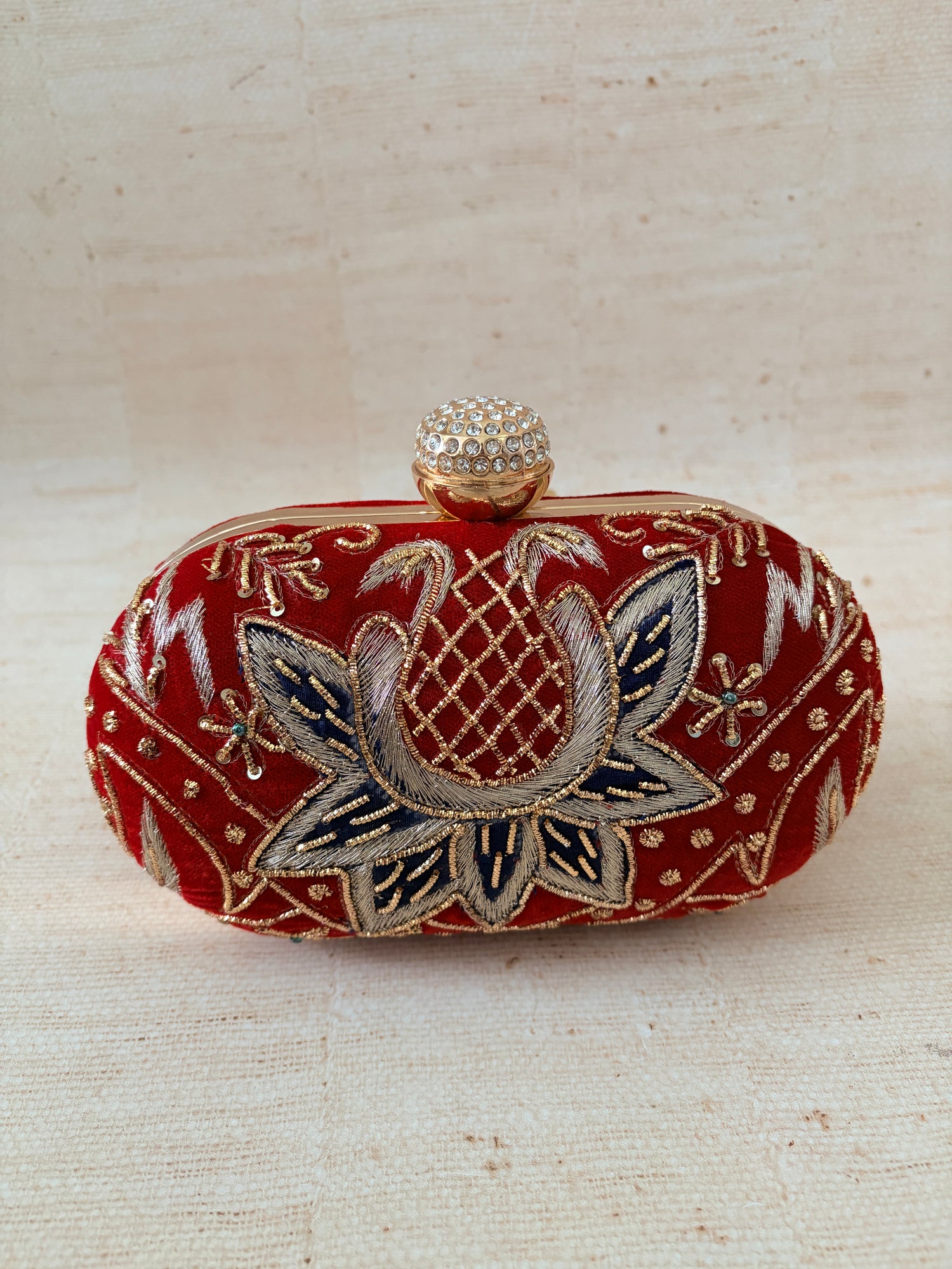 Decorative clutch with floral patterns on a beige background