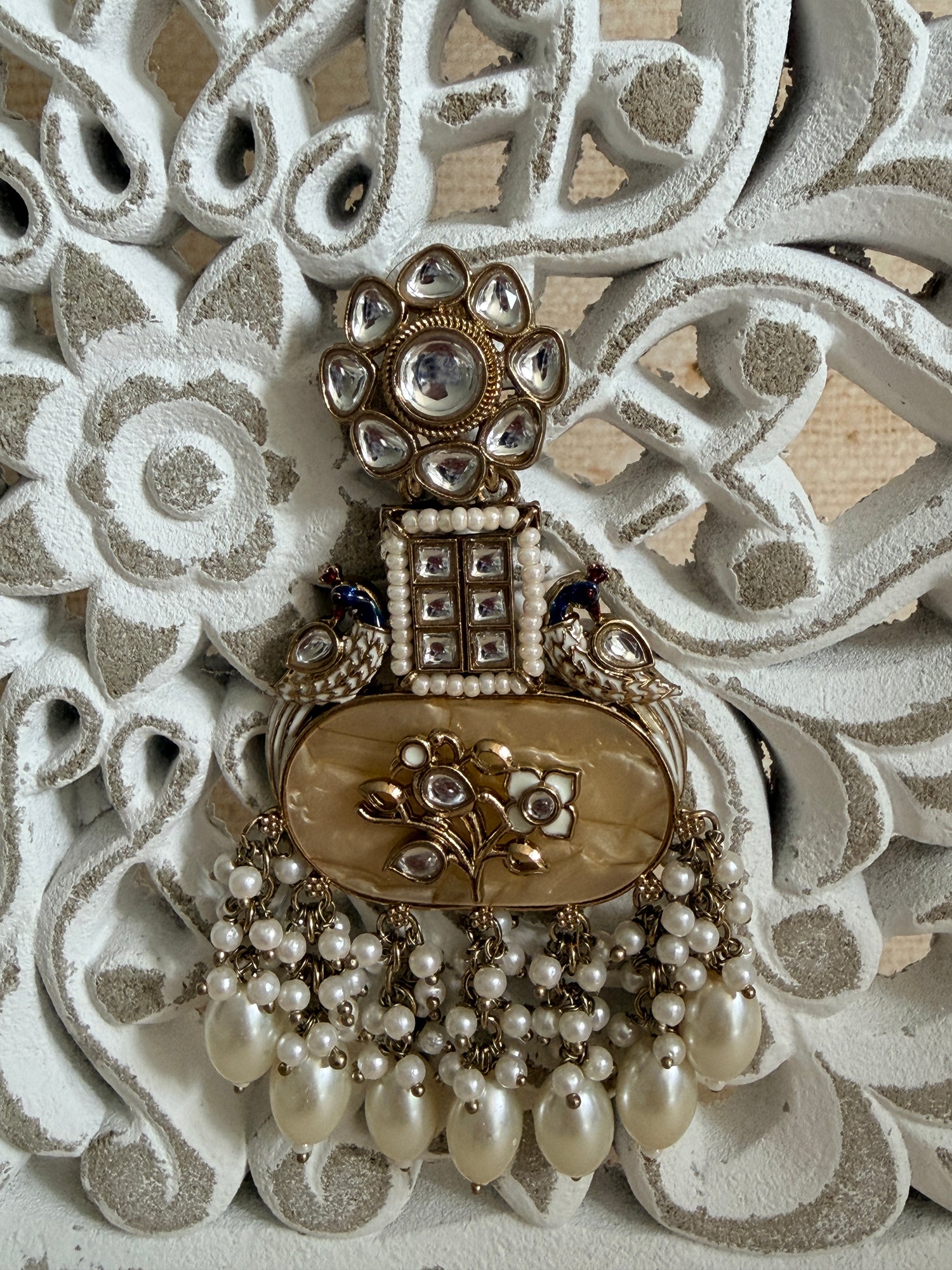 Decorative key with pearls on a textured white background
