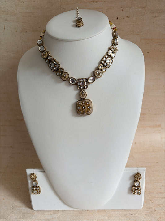 Jewelry set on a white mannequin bust against a beige background